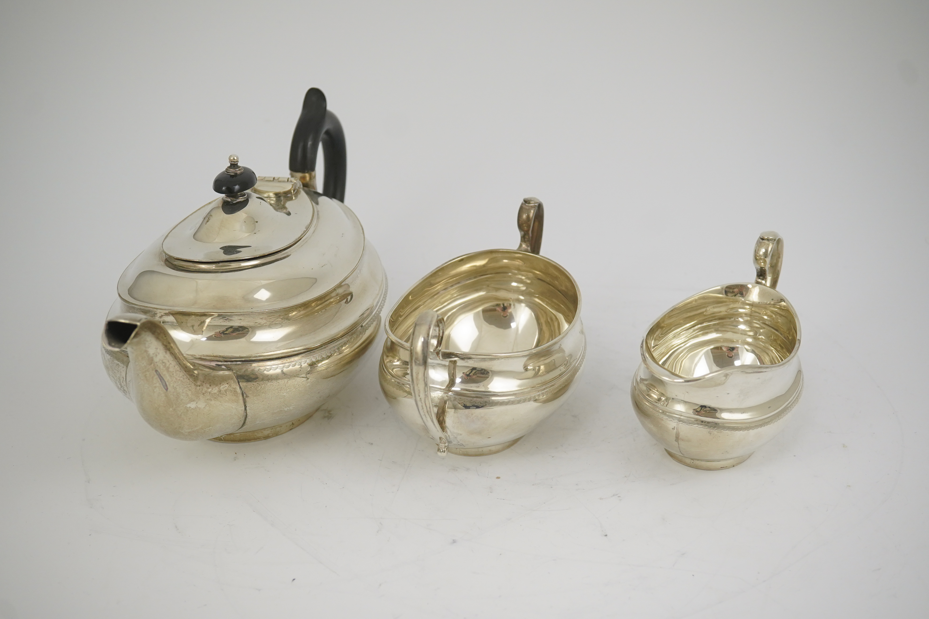 A George V silver three piece oval tea set, by Viners Ltd